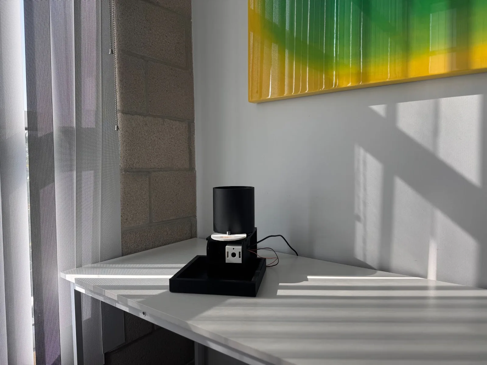 The feeder on a table by a window